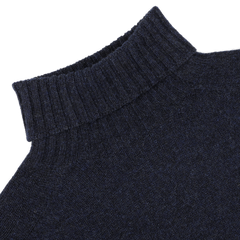 Crafted by Harley of Scotland, the Cosmos Blue Extrafine Lambswool Rollneck features a textured knit pattern and classic rollneck in navy blue.