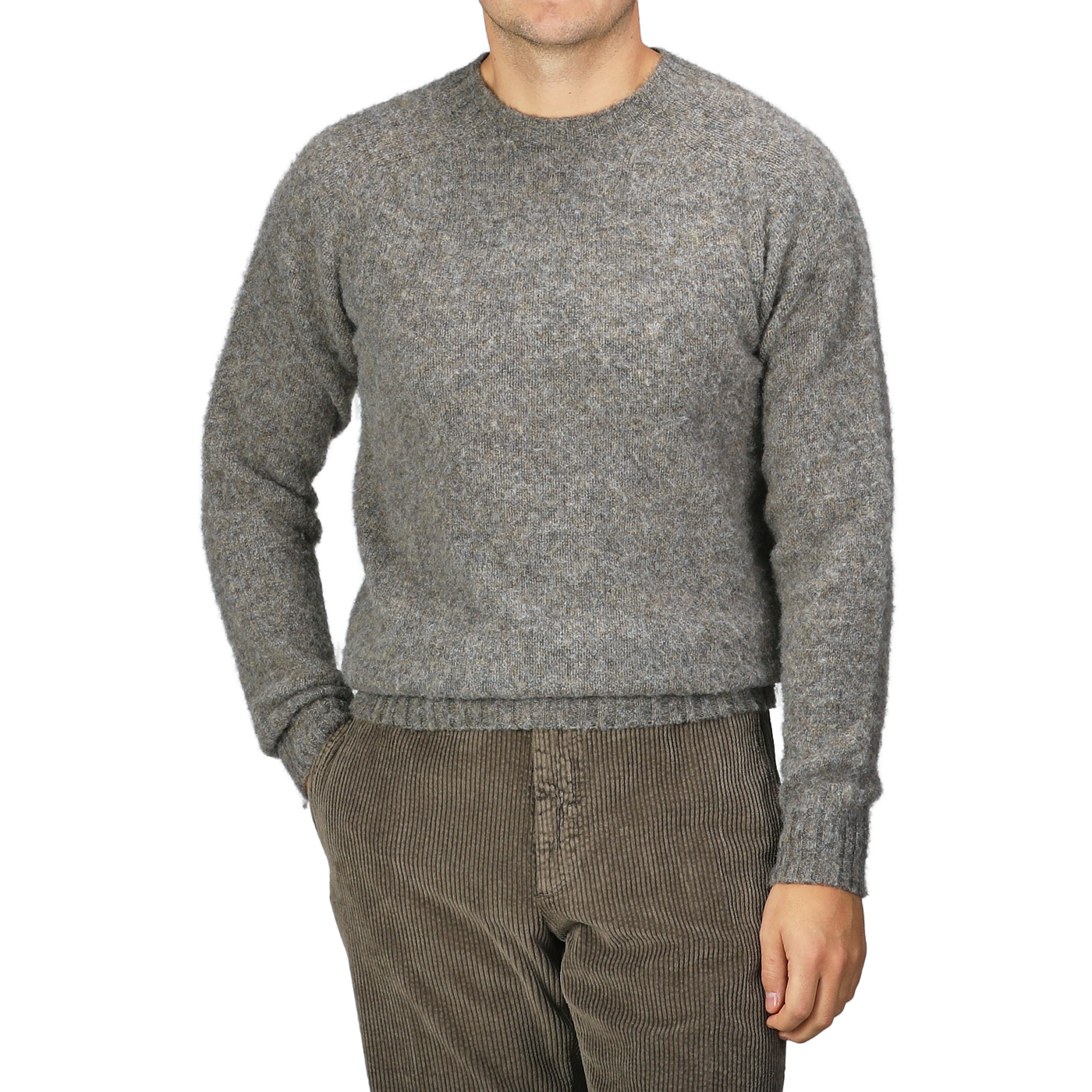 A person wearing the Oyster Grey Brushed Shaggy Wool Crewneck by Harley of Scotland and brown corduroy pants stands against a plain background.