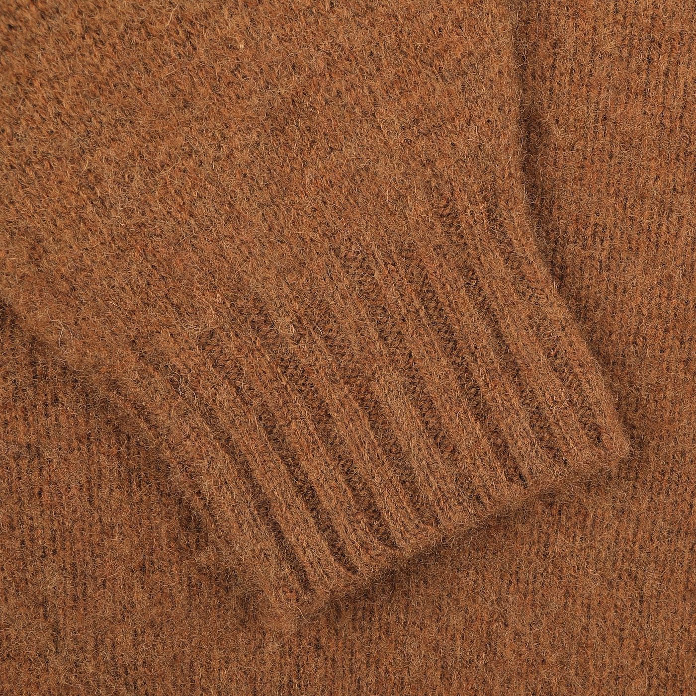 Close-up of the sleeve on a Pecan Brown Brushed Shaggy Wool Crewneck by Harley of Scotland, featuring detailed ribbed cuffs.