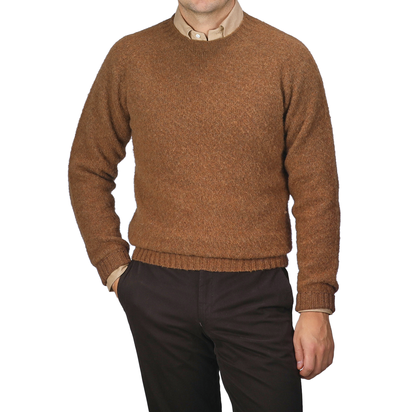 A person wearing a Pecan Brown Brushed Shaggy Wool Crewneck from Harley of Scotland and dark pants is standing with one hand in the pocket against a neutral background.