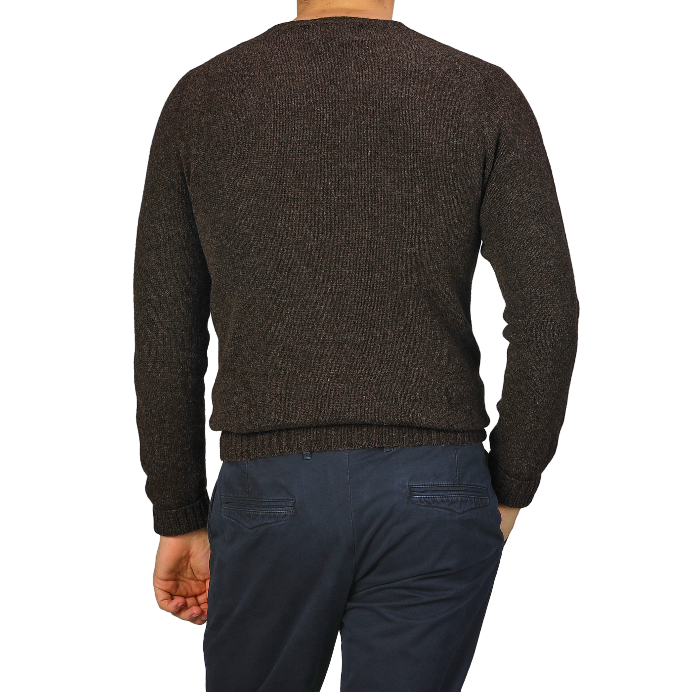 A person wearing a Porcupine Brown Extrafine Lambswool Crewneck by Harley of Scotland and navy pants stands facing away, with one hand in their pocket.