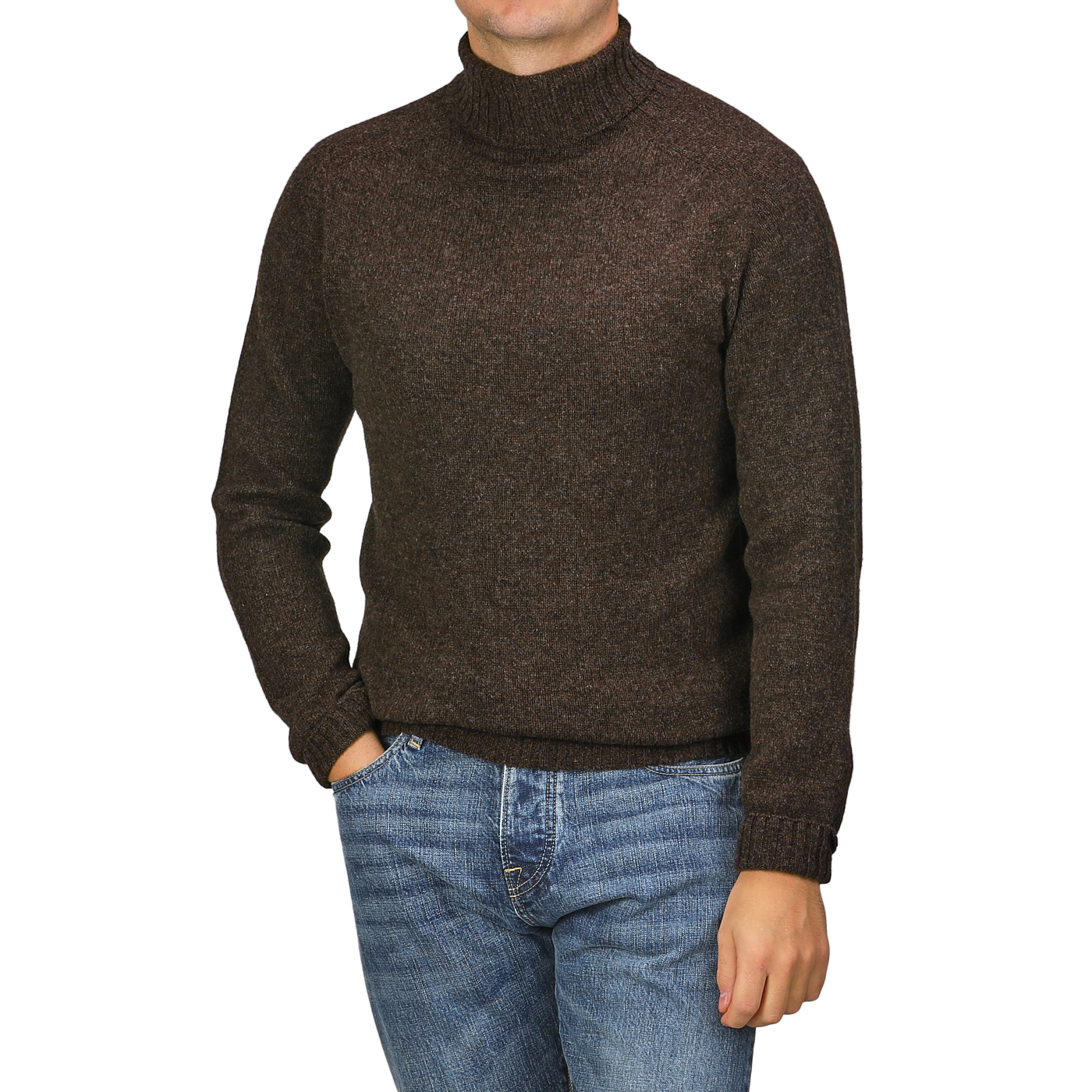 The person is wearing a Porcupine Brown Extrafine Lambswool Rollneck by Harley of Scotland paired with blue jeans, with one hand casually tucked in their pocket.