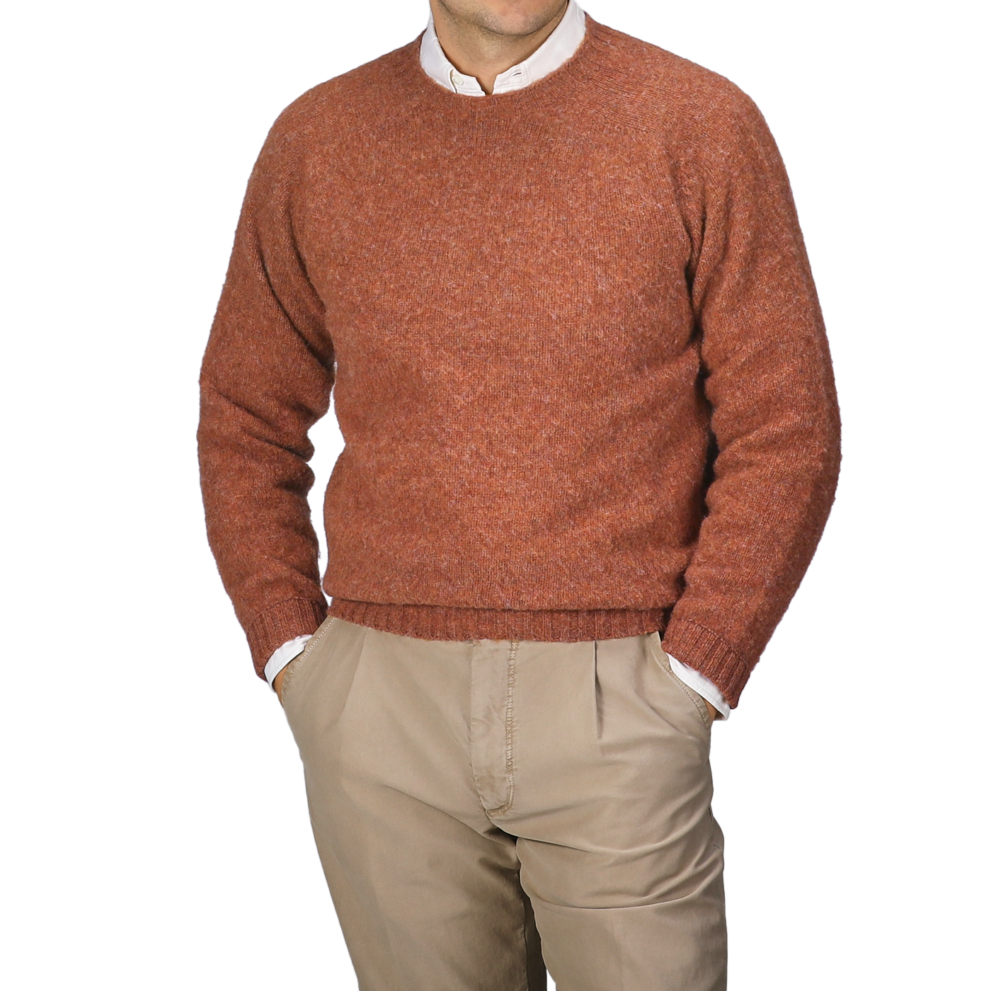 A person wearing a Sienna Brushed Shaggy Wool Crewneck by Harley of Scotland and beige pants, with hands in their pockets, standing against a plain background.