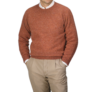 A person wearing a Sienna Brushed Shaggy Wool Crewneck by Harley of Scotland and beige pants, with hands in their pockets, standing against a plain background.