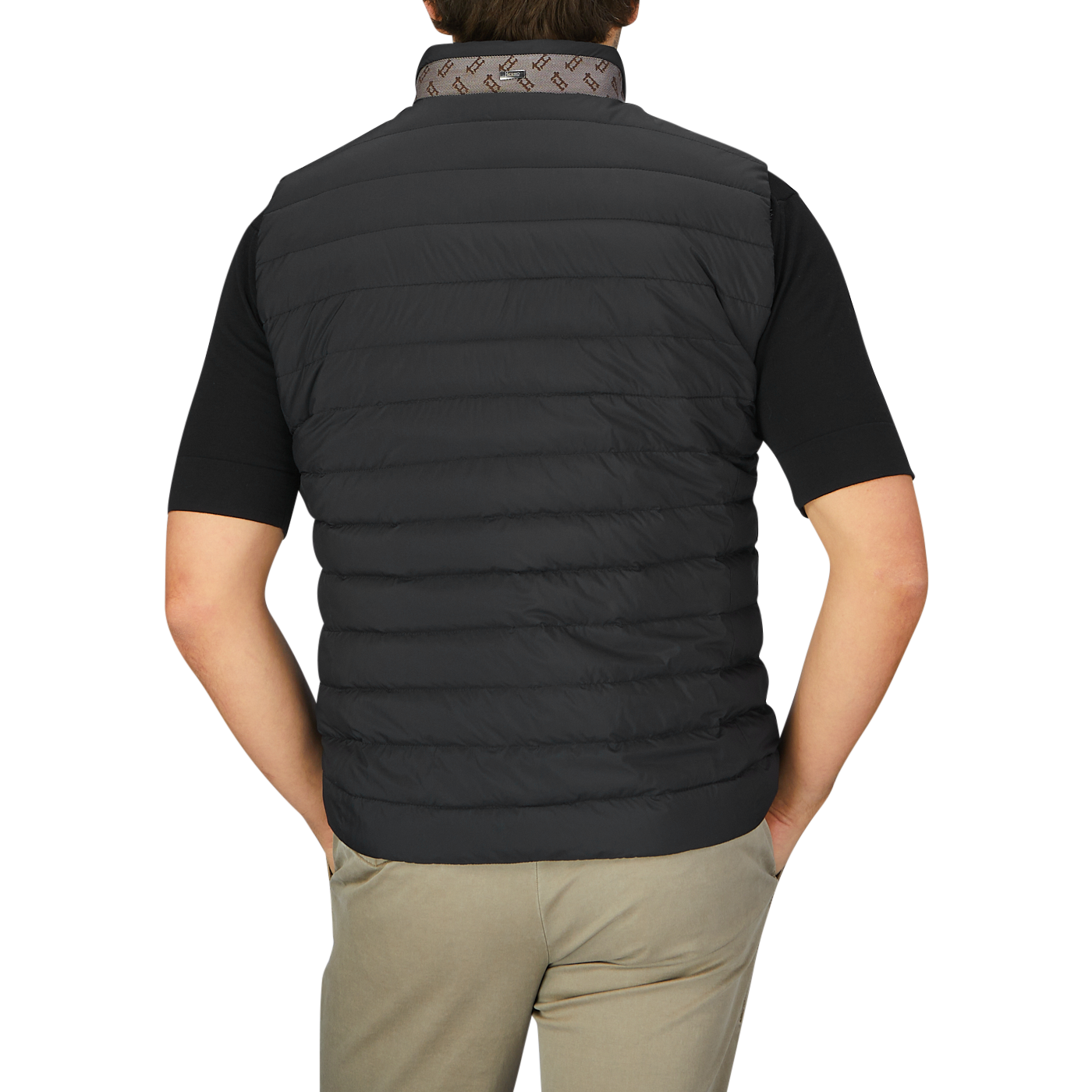 The back view of a man wearing an Italian Herno Black Nylon Goose Down Quilted Gilet.