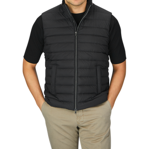 A man wearing a black Nylon Goose Down Quilted Herno gilet.