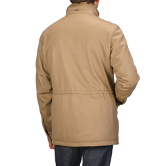 A person wearing a Camel Beige Loro Piana Wool Field Jacket by Herno and dark jeans is seen from the back, showcasing its technical down features crafted for any rain system.