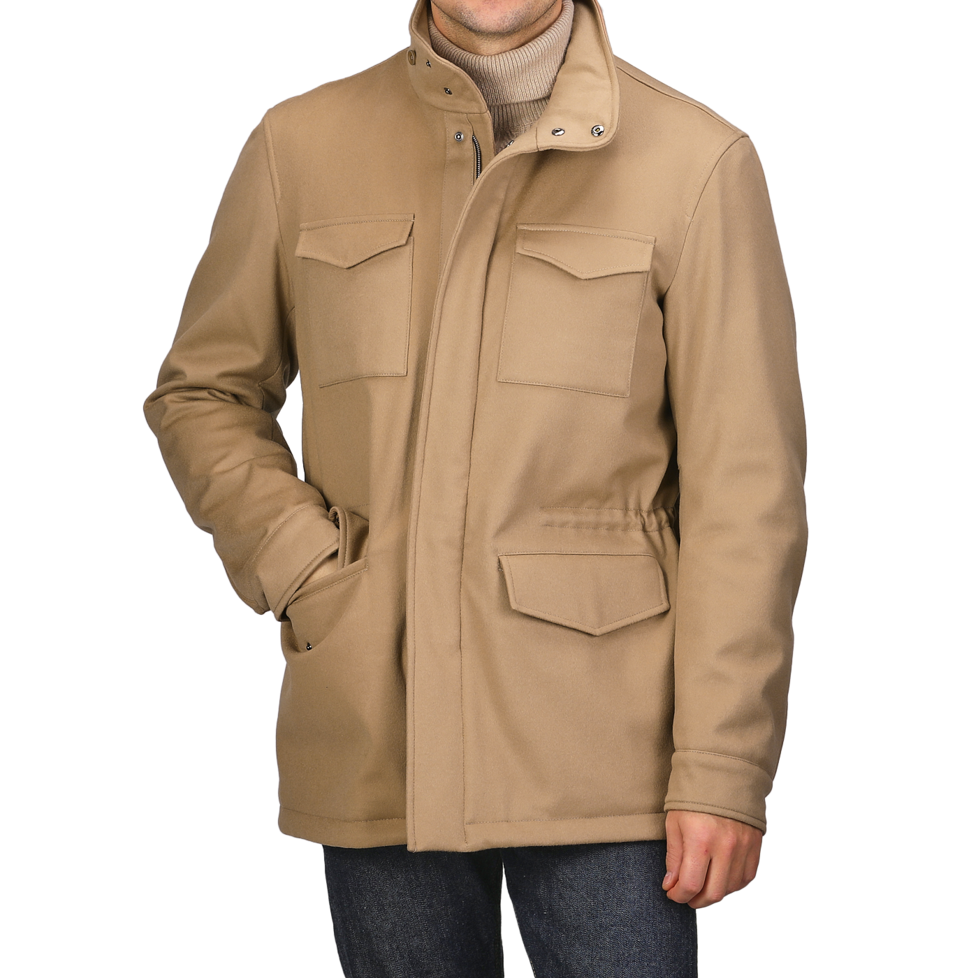 A person is wearing a Camel Beige Loro Piana Wool Field Jacket by Herno, featuring a high collar and flap pockets, with hands tucked in. The stylish jacket, equipped with Rain System technology, pairs perfectly with a turtleneck and jeans.