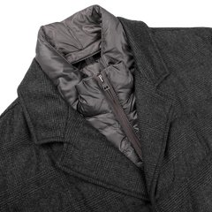 A charcoal checked wool cashmere jacket by Herno, featuring a segmented gray hooded inner lining and a Rain System zip-up closure beneath the collar.