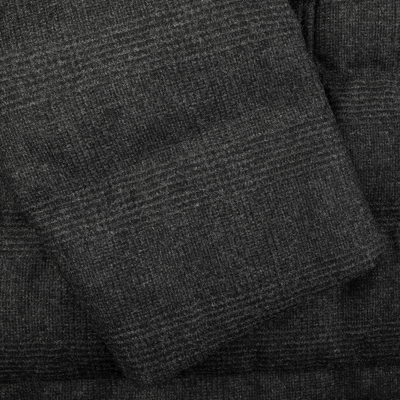 Close-up of a charcoal checked wool-cashmere fabric, ideal for the Herno Charcoal Checked Wool Cashmere Loro Piana Jacket.