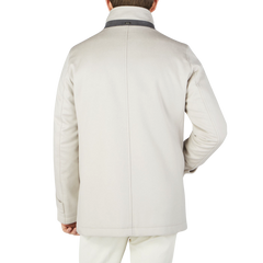 The back view of a man wearing a Cream Beige Water Repellent Cashmere Car Coat by Herno.