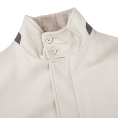 A Cream Beige Water Repellent Cashmere Herno car coat with black buttons.