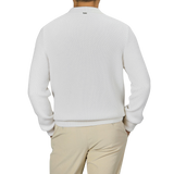 A man shown from the back wearing a Herno Cream White Virgin Wool Knitted Pullover and beige pants against a plain background.