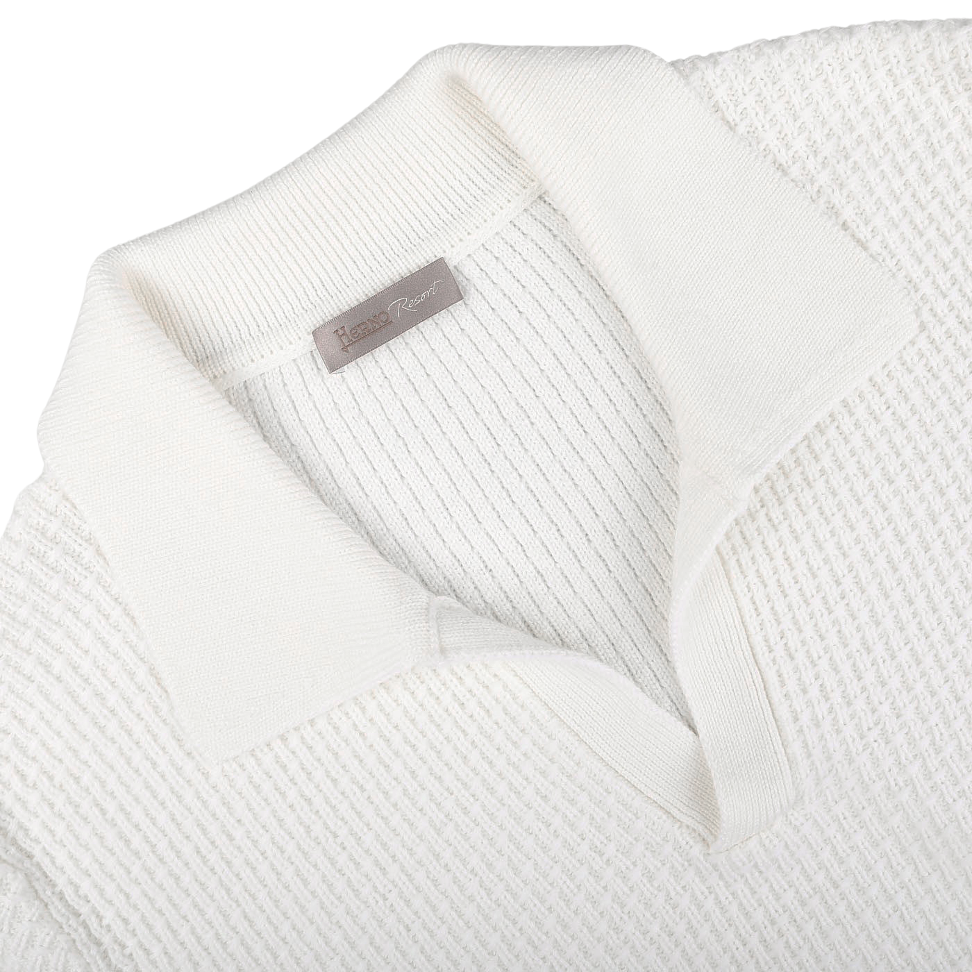 Close-up of the Cream White Virgin Wool Knitted Pullover from Herno, showcasing a textured design and a ribbed collar. The tag reads "Hand Room," evoking the essence of Herno's Resort collection.