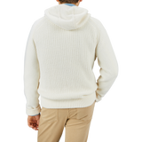A person wearing a Herno Cream Wool Nylon Reversible Knitted Jacket and tan pants is standing facing away from the camera against a plain background.