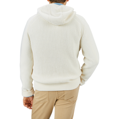 A person wearing a Herno Cream Wool Nylon Reversible Knitted Jacket and tan pants is standing facing away from the camera against a plain background.