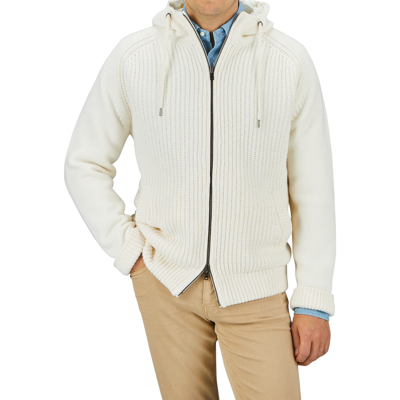 A person is wearing a Herno Cream Wool Nylon Reversible Knitted Jacket, crafted from virgin wool, with a front zipper over a blue shirt, paired with beige pants. The person's hands are in their pockets. Only the torso is visible.