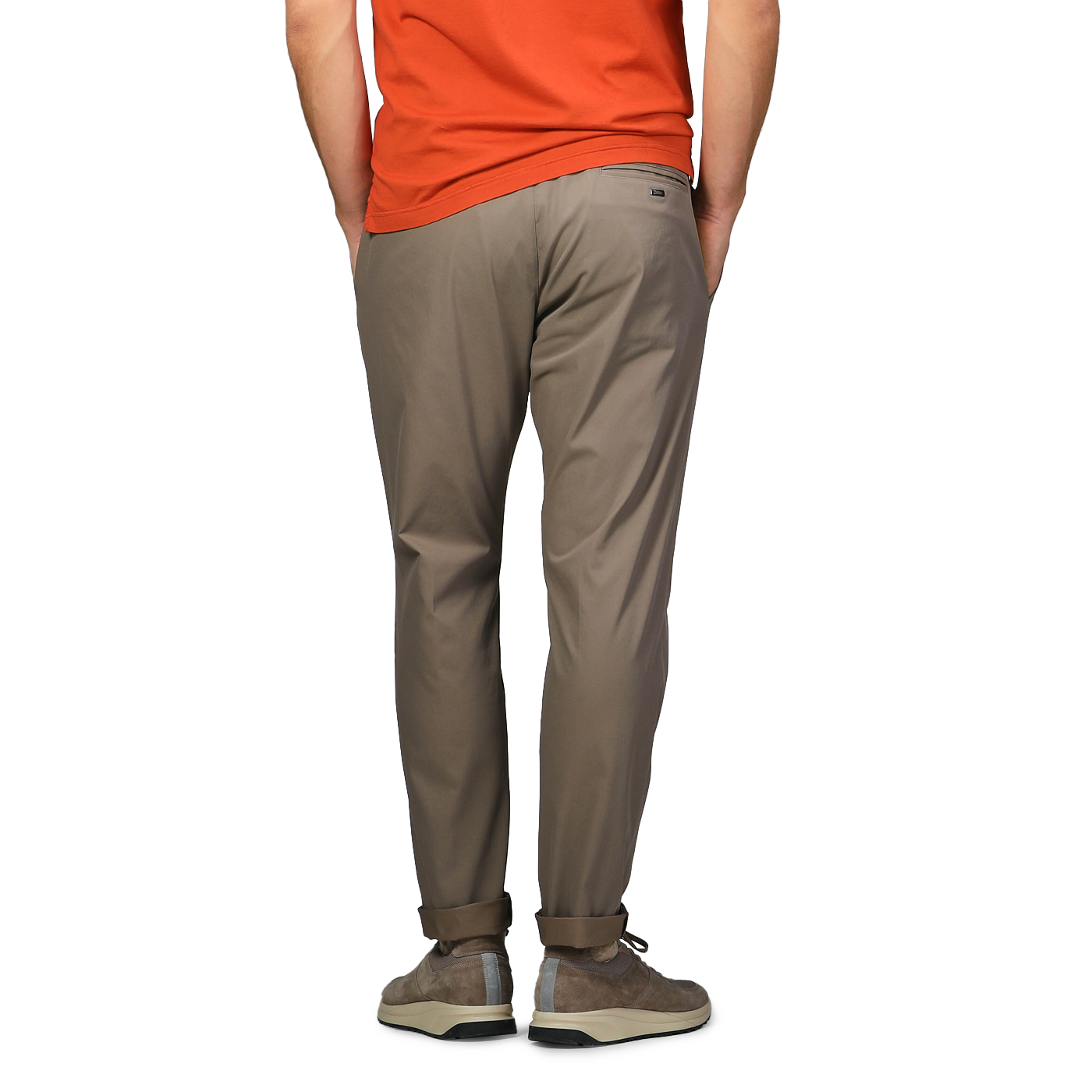 A person in an orange shirt stands with hands in pockets, facing away, wearing Herno's Dark Beige Nylon Stretch Drawstring Trousers.