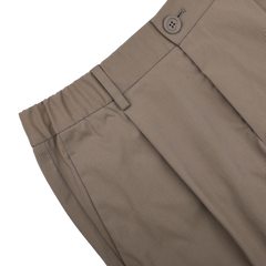 Herno's dark beige nylon stretch drawstring trousers in a slim fit are presented from the side against a black background.