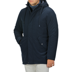 A person in a Herno Dark Blue Nylon Technical Padded Jacket and light-colored pants stands with their right hand in their pocket.