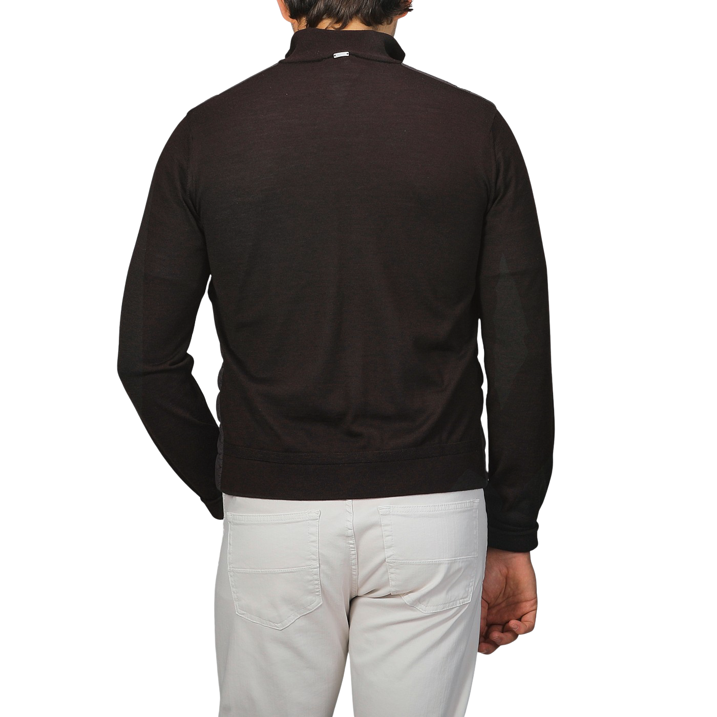 A person wearing a dark brown wool silk nylon padded jacket by Herno, paired with a black long-sleeve shirt and white pants, is shown from the back against a plain background.