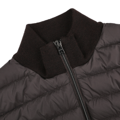 Close-up of Herno's Dark Brown Wool Silk Nylon Padded Jacket, featuring a zippered front and ribbed collar, highlighting its quilted texture.