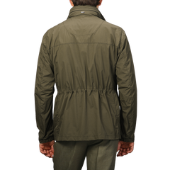 Seen from the back, a person wears Herno's Dark Green Ultralight Nylon Field Jacket with wind and rain resistance, featuring an elastic waistband.