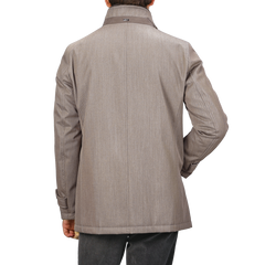 A person is seen from behind wearing a luxurious Light Brown Loro Piana Wool Twill Jacket by Herno, which features a clean and simple design.