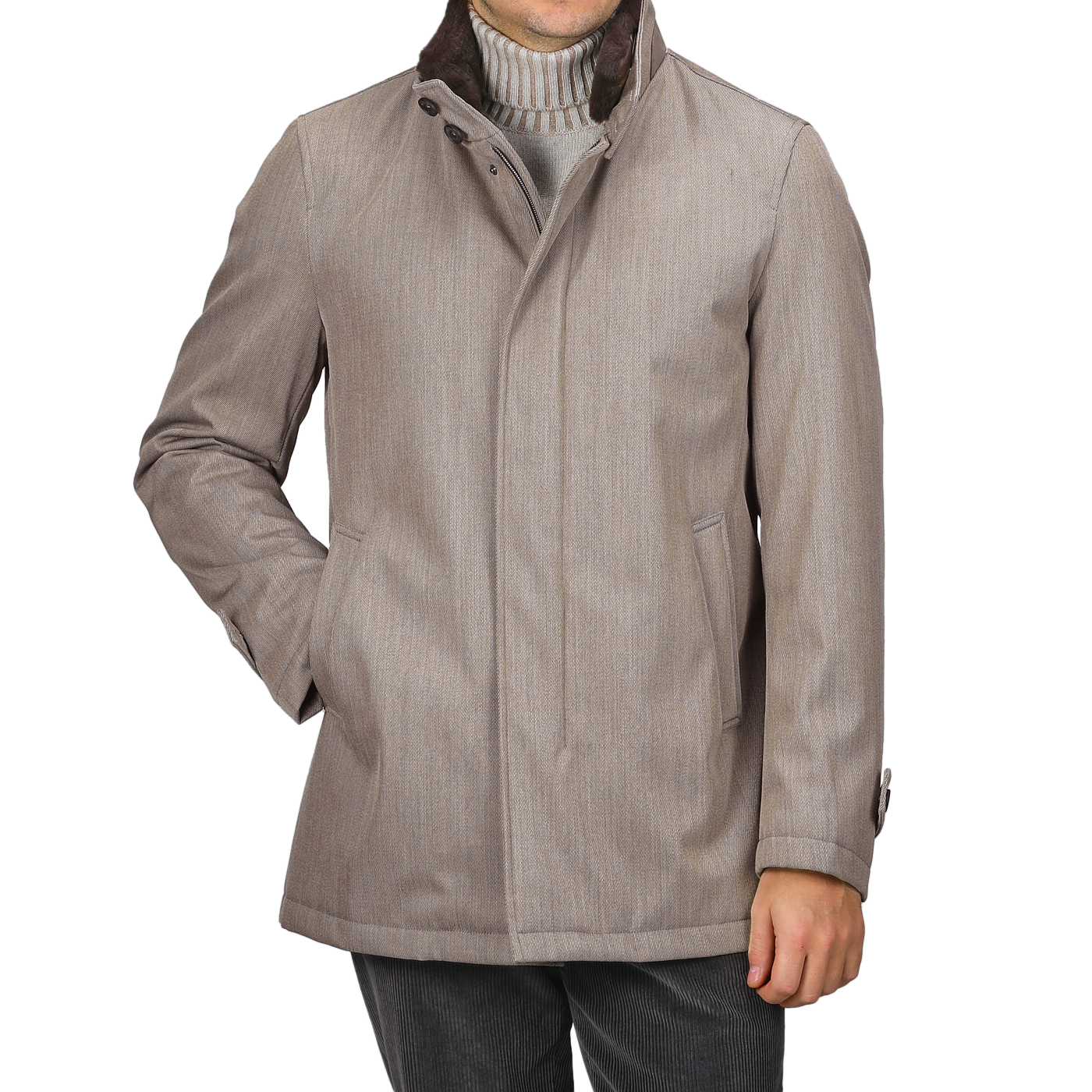 A person is dressed in a sophisticated and practical ensemble, featuring the Herno Light Brown Loro Piana Wool Twill Jacket with a high collar over a pure wool gray turtleneck sweater, paired with dark trousers. The rain-resistant jacket is buttoned up, showcasing its luxurious design.