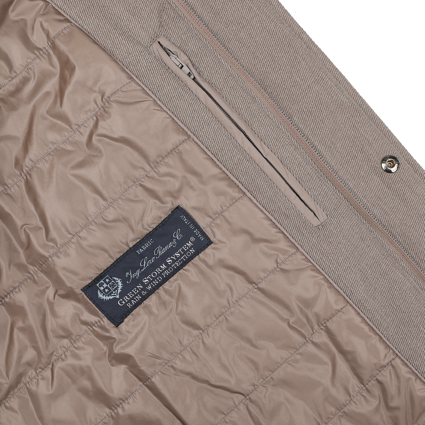 Close-up of the interior of a luxurious Light Brown Loro Piana Wool Twill Jacket by Herno, featuring a quilted lining with a label that reads "Loro Piana S.P.A. Garment with Storm System Protection," crafted from pure wool for a rain-resistant finish.