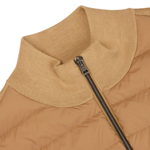 Close-up of a Herno light camel wool silk nylon padded jacket with a ribbed collar and a partially zipped silver zipper.
