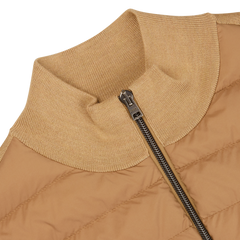 Close-up of a Herno light camel wool silk nylon padded jacket with a ribbed collar and a partially zipped silver zipper.