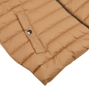 Close-up of a Herno Light Camel Wool Silk Nylon Padded Jacket with a zipper and a visible logo on the snap button.