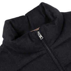 Close-up of a navy blue, water-repellent cashmere silk bomber jacket by Herno, with a zipper partially unzipped, revealing the collar design and stitching details.