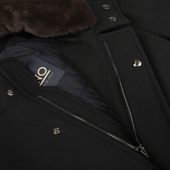 Close-up image of a navy blue technical coat with a visible zipper and branded label. The Navy Blue Diagonal Wool Padded Coat by Herno features metal snap buttons, thermal insulation, and a fur collar.