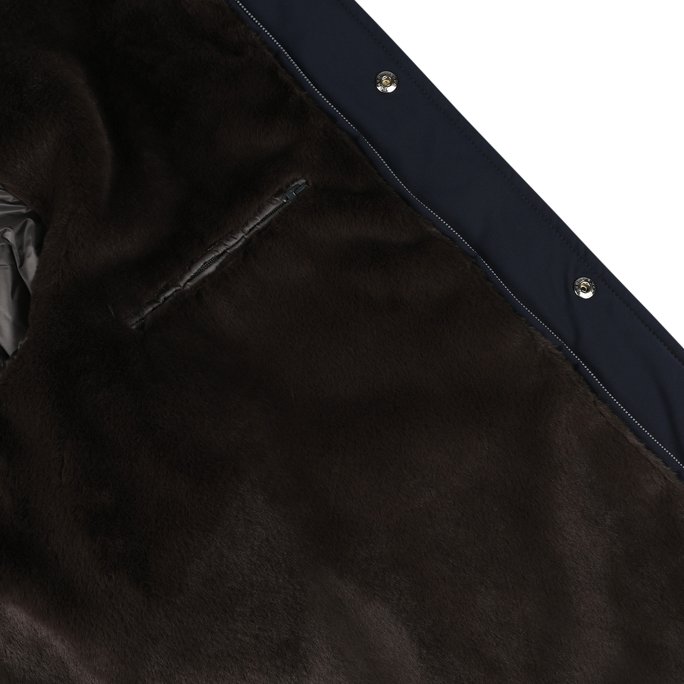 Close-up of a dark brown, faux fur-lined Herno Navy Blue Faux Fur Lined Nylon Car Coat with metallic snap buttons along the edge. A small zipper pocket is visible on the luxurious faux fur lining.