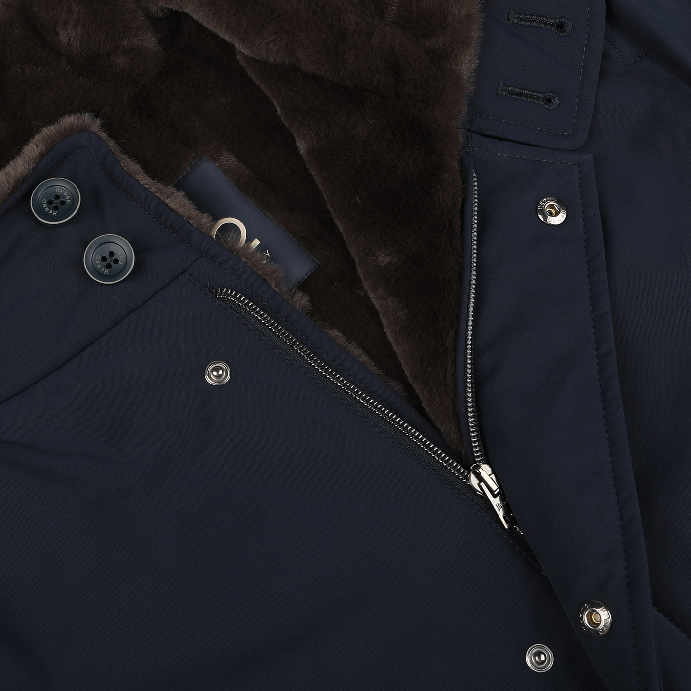 Close-up of the Herno Navy Blue Faux Fur Lined Nylon Car Coat, featuring a zipper and button closure with a dark brown faux fur lining.