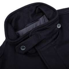 Close-up of the Herno Navy Blue Loro Piana Wool Field Jacket, designed to be rain-resistant and crafted from pure wool, featuring a high collar with two black buttons on the collar strap.