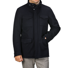 A person wearing a Herno Navy Blue Loro Piana Wool Field Jacket with four pockets over light gray pants.