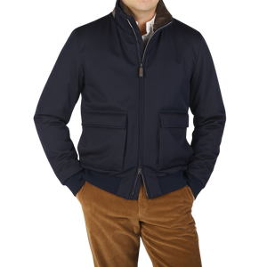 A man wearing a Herno Navy Blue Loro Piana Wool Twill Bomber Jacket and brown pants.