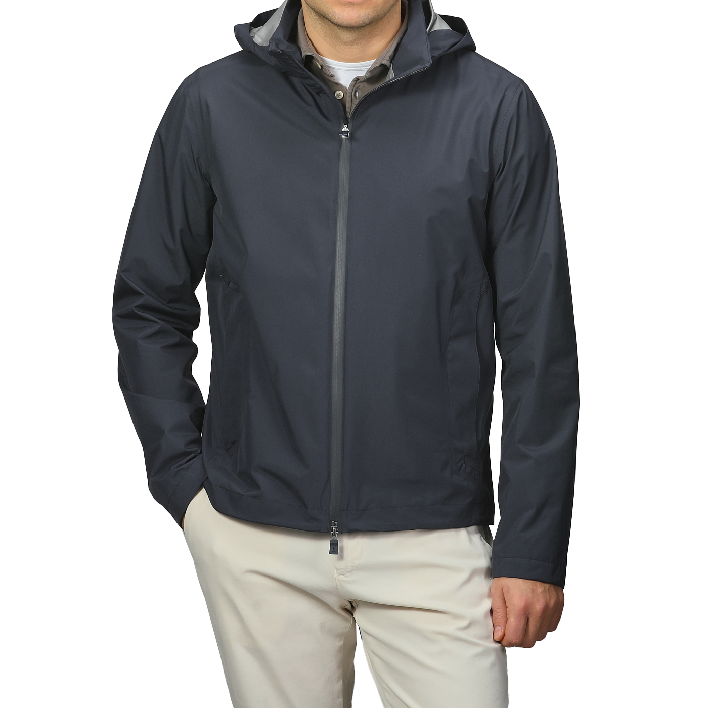 A person in a Herno Navy Blue Nylon Gore-Tex Blouson with light pants stands with one hand in their pocket.