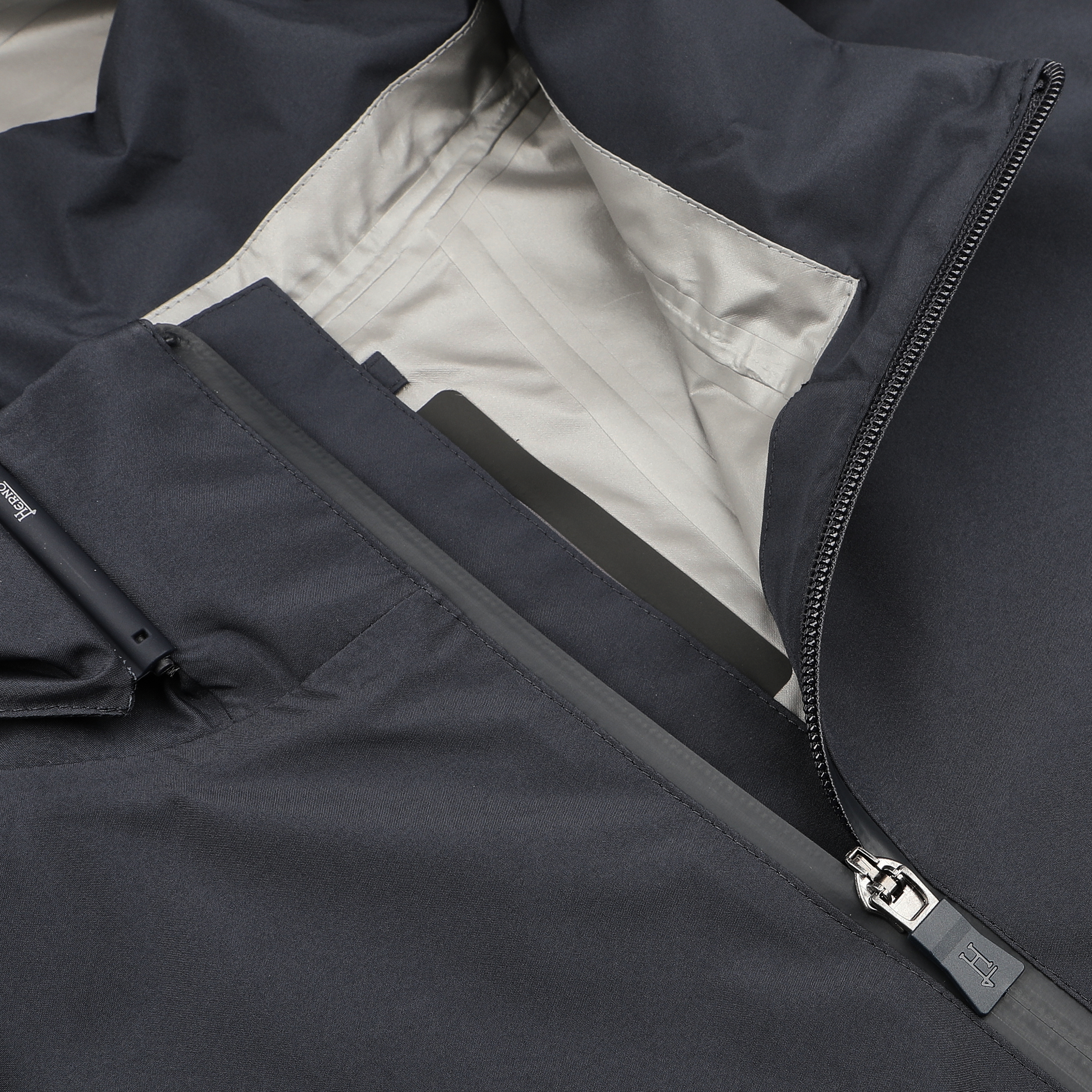 Close-up of a Navy Blue Nylon Gore-Tex Blouson by Herno, featuring an open pocket and partially visible inner lining with a zipper, showcasing the craftsmanship of Italian outerwear.