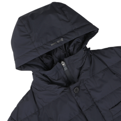 A Navy Blue Nylon Gore-Tex Laminar Coat by Herno is displayed with the hood up and a visible front zipper closure. This shiny, dark-colored jacket features a goose down fill and boasts a puffy quilted design.