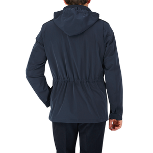 The back view of a man wearing a Herno Navy Blue Nylon Hood Field Jacket.