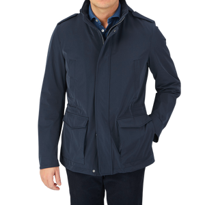 A man wearing a Herno navy blue nylon hood field jacket.