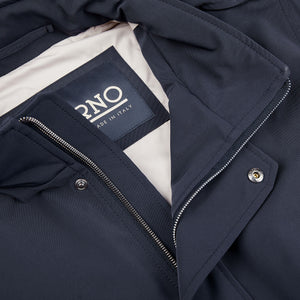 A close up of a Herno navy blue nylon hood field jacket with a label on it.