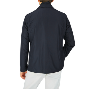 The back view of a man wearing a Herno Navy Blue Nylon Hybrid Blazer.
