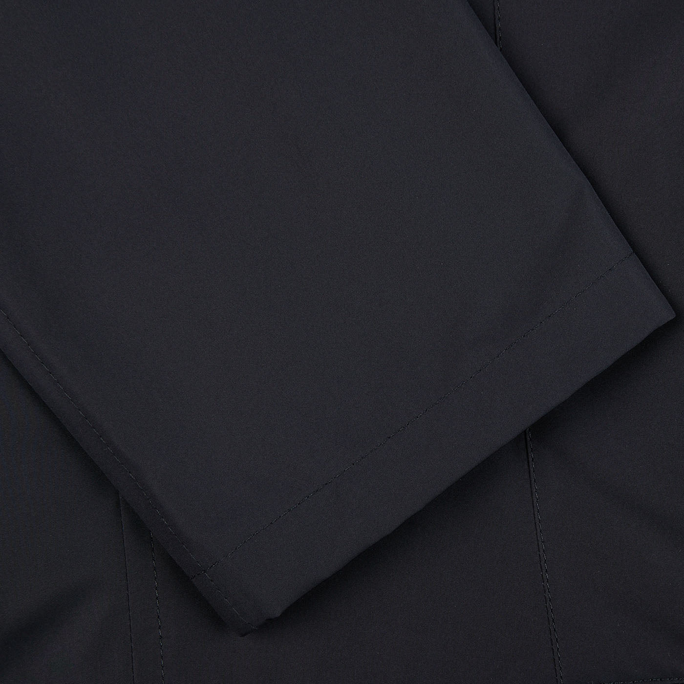 A close up of the pocket of a Herno Navy Blue Nylon Hybrid Blazer.