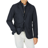 A man wearing a Herno Navy Blue Nylon Hybrid Blazer and white pants.