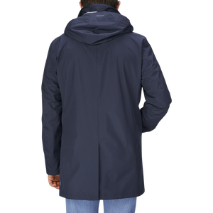 The back view of a man in a Herno Navy Blue Nylon Laminar Car Coat.